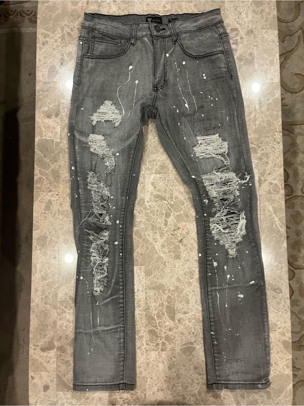 Waimea grey distressed paint-splattered skinny jeans .
